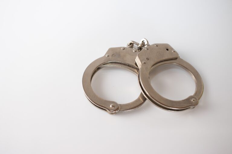 1071586-high-angle-shot-metal-handcuffs-isolated.jpg