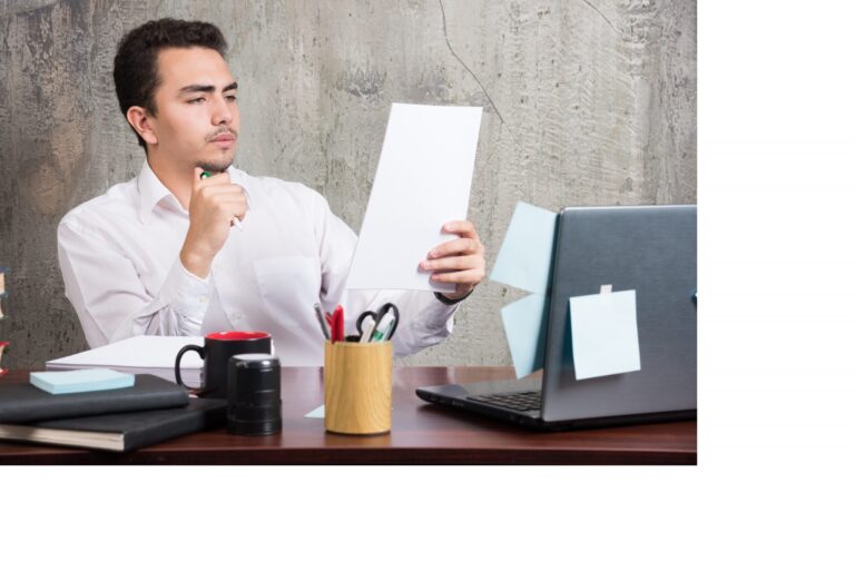 young-businessman-looking-work-papers-office-desk-scaled.jpg