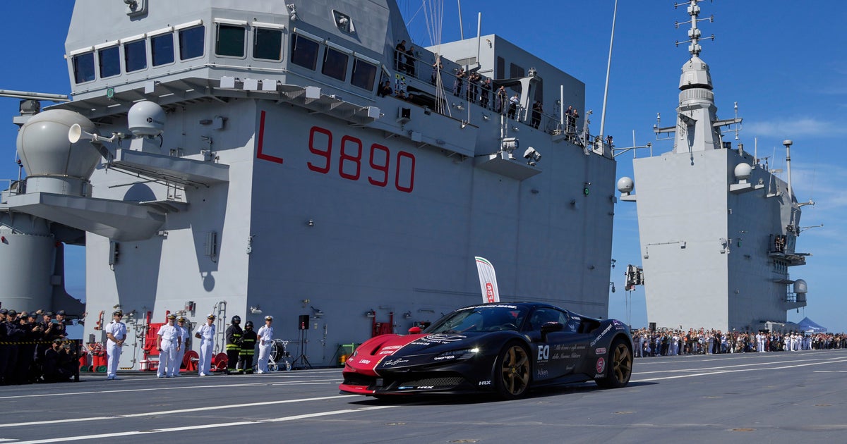 Man in a Ferrari on an aircraft carrier attempts to set record for fastest car driven on a boat