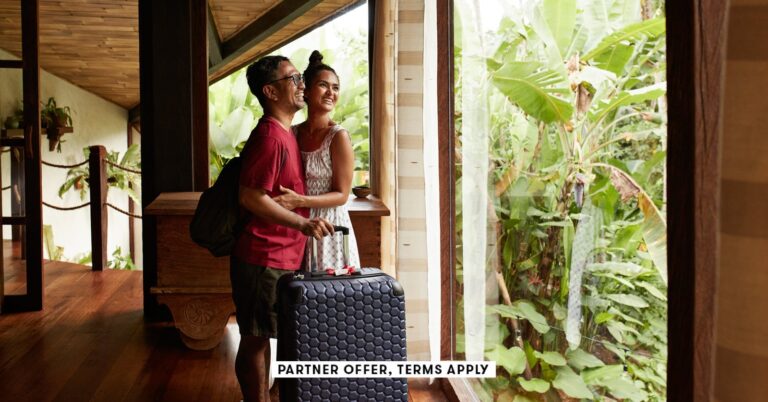 SOCIAL-IMAGE_PARTNER-OFFER-TERMS-APPLY_Couple-standing-near-window-at-villa-with-suitcase_Klaus-Vedfelt_27.jpg
