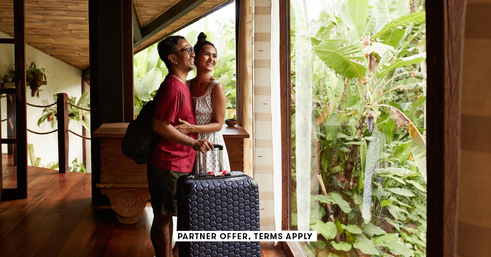 SOCIAL-IMAGE_PARTNER-OFFER-TERMS-APPLY_Couple-standing-near-window-at-villa-with-suitcase_Klaus-Vedfelt_27.jpg
