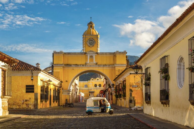 A-tuk-tuk-taxi-passes-in-front-of-the-Arch-of-Santa-Catalina-in-Antigua-Guatemala_-THEPALMER.jpg