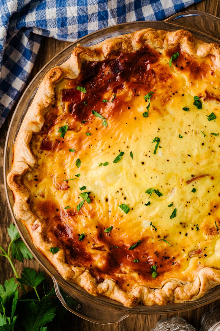 हैम और पनीर को डीप-डिश पाई क्रस्ट में पकाया गया, ऊपर से सुनहरा और ओवन से ताज़ा।